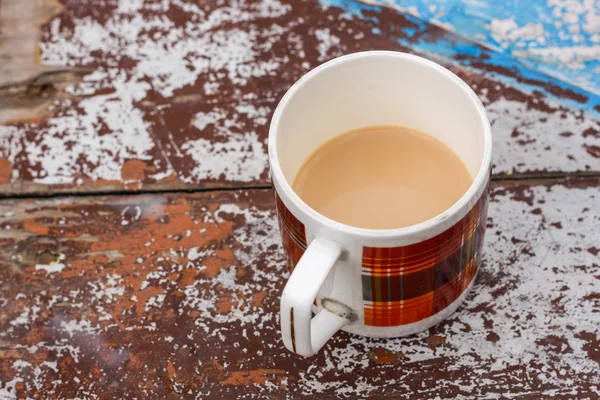 Mug with coffee and milk on rustic table
