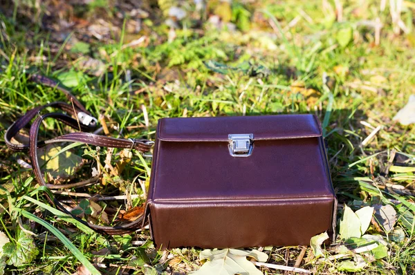 Leather brown briefcase at grass background