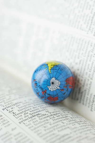 Germany,Close up of earth globe on open dictionary