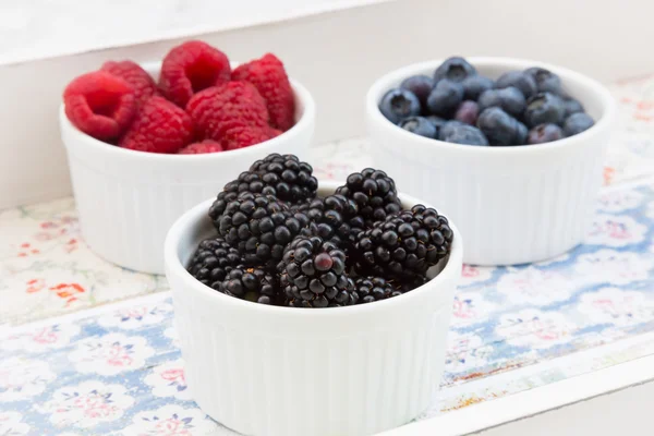 Wild berries, Raspberries, blueberries and blackberries in bowls