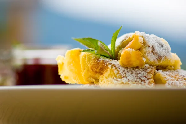 Cut-up pancake on plate, close-up