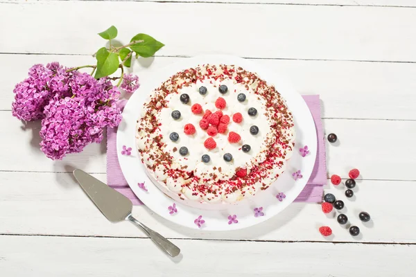 Raspberry-cream cake with raspberries and blueberries