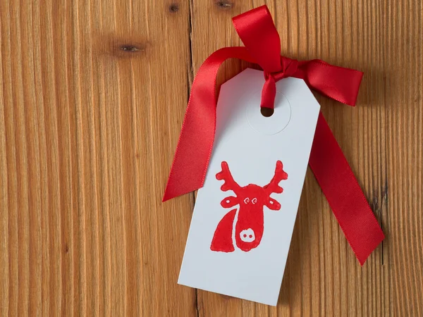 Christmas, gift tag, printed, red ribbon, background wood