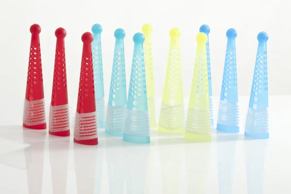 Multi-colored hair curlers on white background