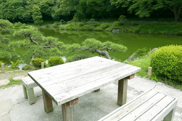 Wooden outdoor furniture table and chair in zen garden