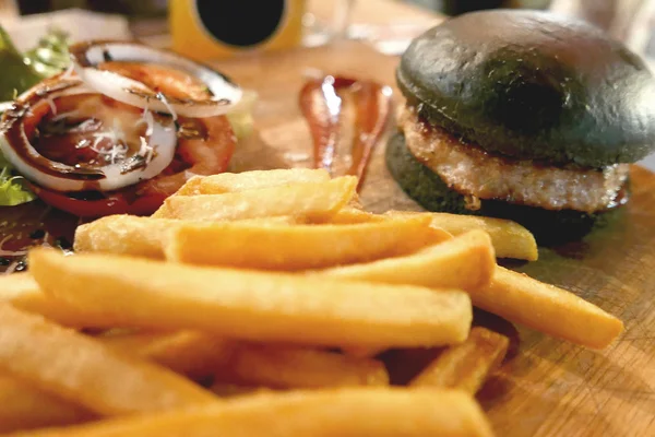 Black burger meal with french fries