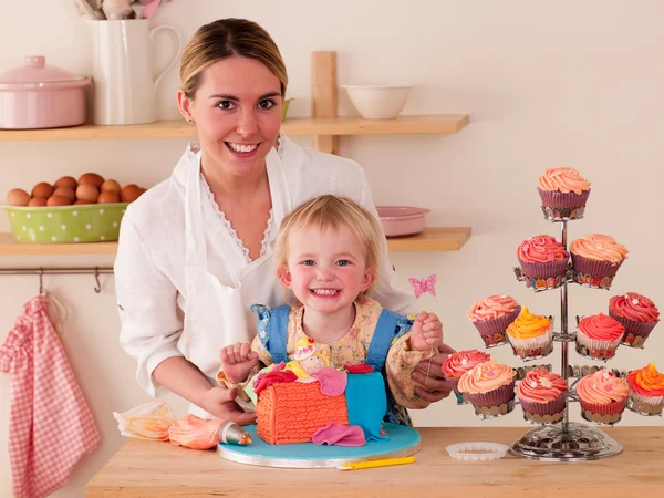 Mother and Daughter decorating cakes together