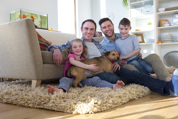 Male couple posing with son, daughter and dog