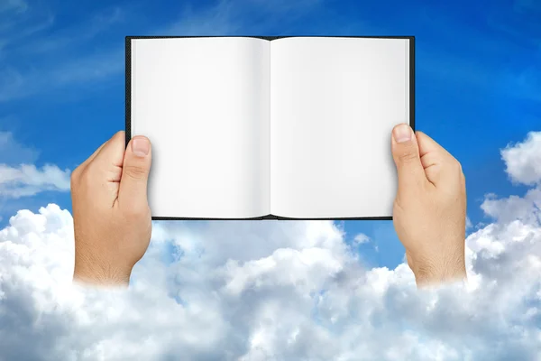 Hands Holding Blank Open Book among Clouds