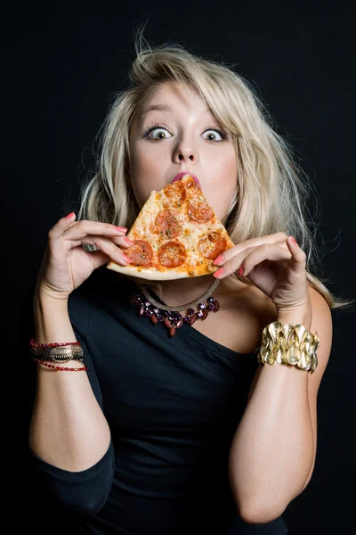 Young happy beautiful woman eating pizza