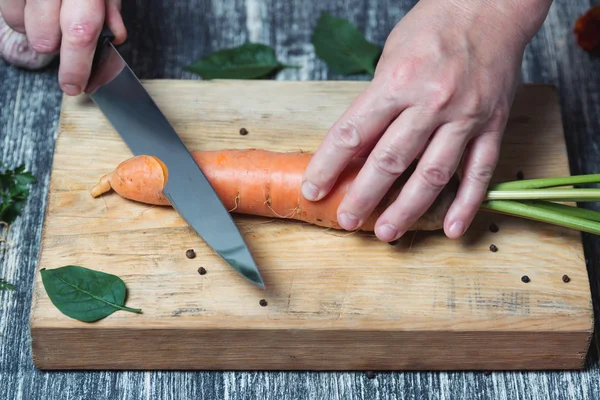 Carrots on a chopping board with knife