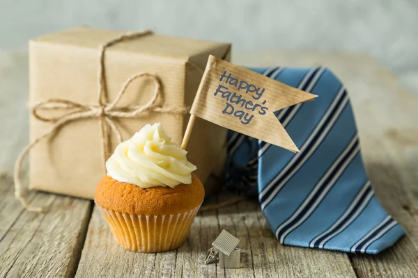 Fathers day concept - cupcake, tie, present