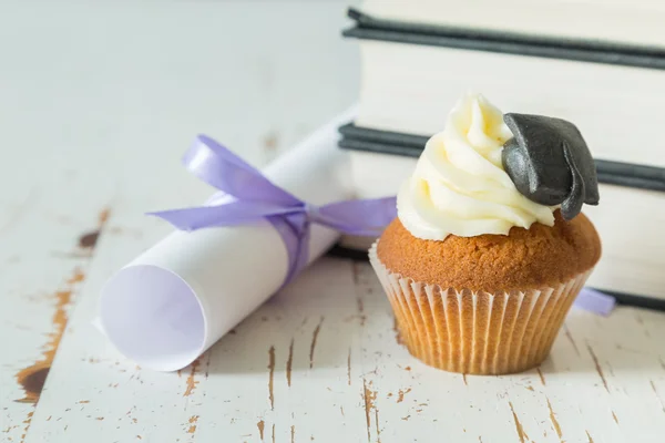 Graduation concept - cupcake with academic cap