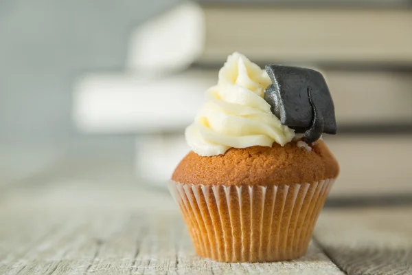 Graduation concept - cupcake with academic cap