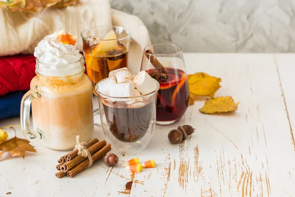 Selection of autumn drinks on wood background