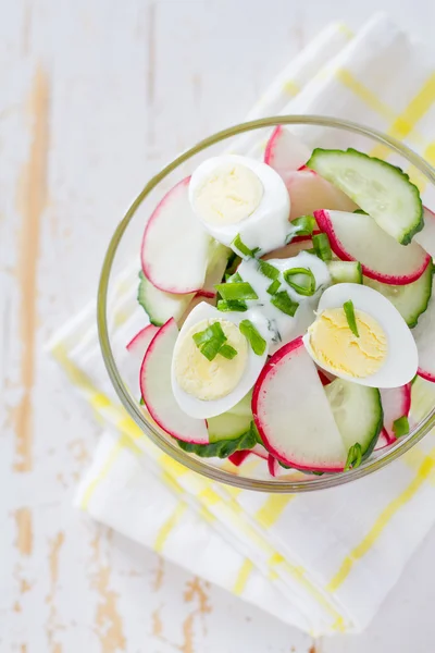 Yogurt salad in glass bowl with ingredients