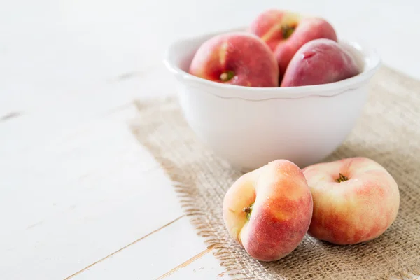 Peaches in white bowl