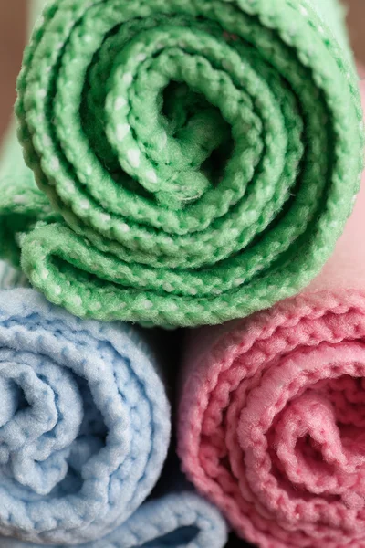 Colored bath towels rolls close up