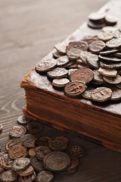 Ancient copper coins on the old book