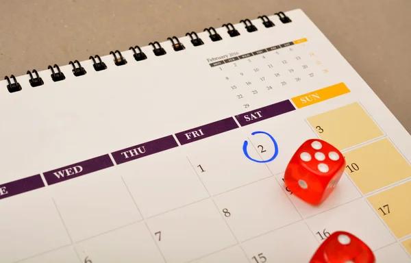 Blue Circle marked on Calendar with Red Dice
