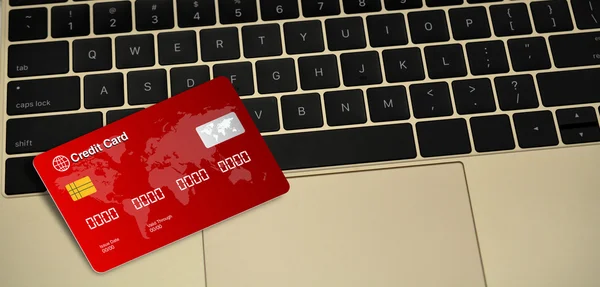 Red Credit card on laptop keys
