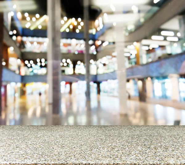 Marble empty table in front of blurred mall