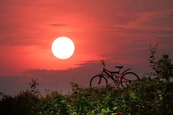 Mountain bike with a colorful sky and sunset.