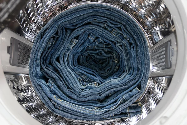 Blue jeans inside the washing machine.