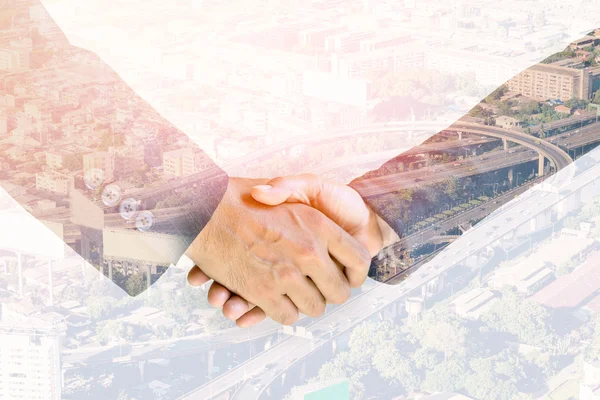 Double exposure handshake of business peoples