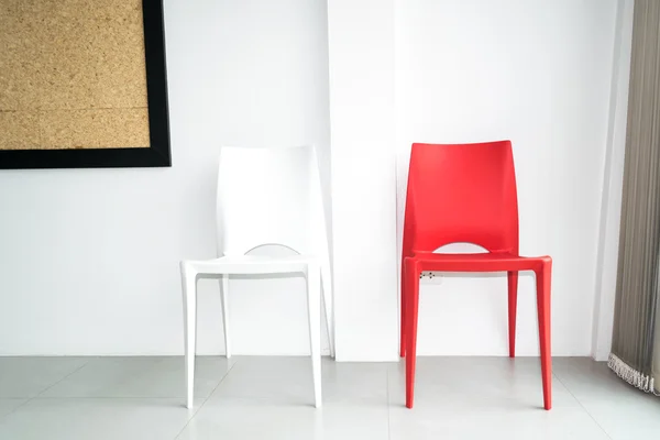 Red and white chairs on the white room