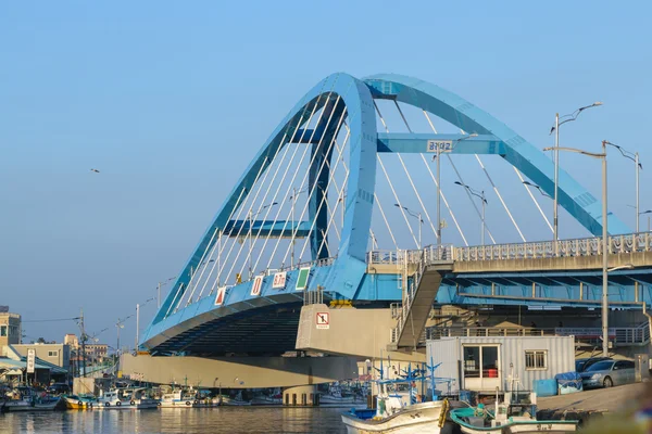 Bridge over river at fishing village in Korea.