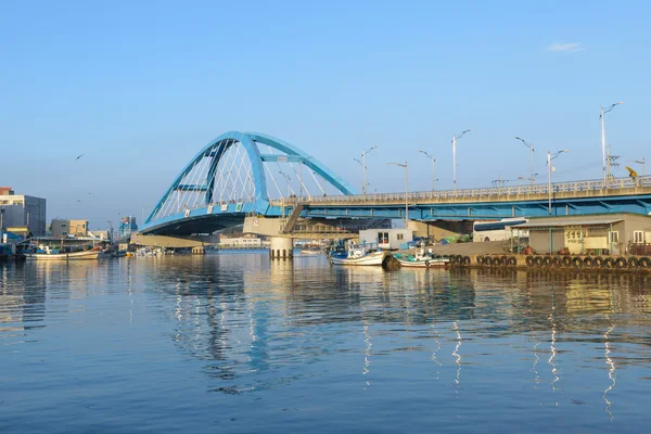 Bridge over river at fishing village in Korea.