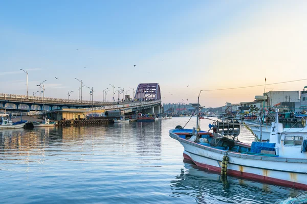 Bridge over river at fishing village in Korea.