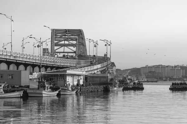 Bridge over river at fishing village in Korea.