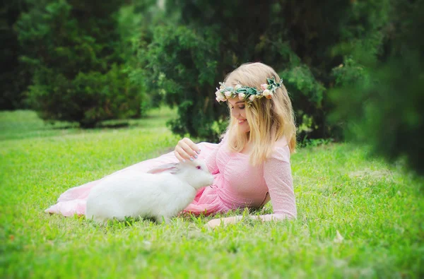 Alice in Wonderland, fairy rabbit play with a rabbit, white rabbit, wreath, girl, blond, cute girl, grass, lying, smile, sincere smile, playing with rabbit, rabbit train, games in nature, nature, wreath of roses, roses, dress, pink, lace, iron rabbit