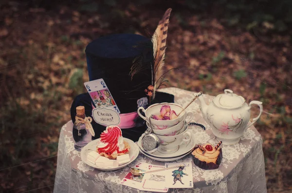 Hat, hatter, pen, tea party, Alice in Wonderland, Through the Looking-Glass, fairy tale, fantasy, scenery, eat me, drink me, candy, bubble, liquid, magic potion, table, tablecloth, lace, saucer, tea, tea, cup, dried roses, spoons, lens