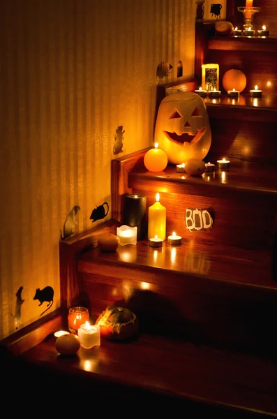 Holiday, event, halloween, pumpkin, orange, candles, lit candles, rat, mouse, scary pumpkin, staircase, wooden staircase, cook a potion Halloween, photo ideas halloween decor, decor on the stairs to the day of All Saints,