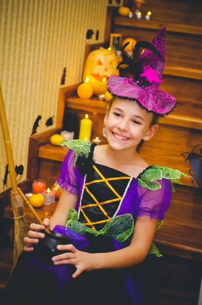 Holiday, event, halloween, pumpkin, orange, candles, lit candles, rat, mouse, scary pumpkin, ladder, wooden ladder, girl, witch, little witch, witch costume, brew a potion, broom, broom for witches, smiling, witch hat , bell witch, Halloween, Hallow