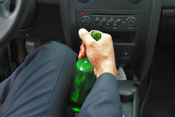 Drunk driver with bottle in his hand