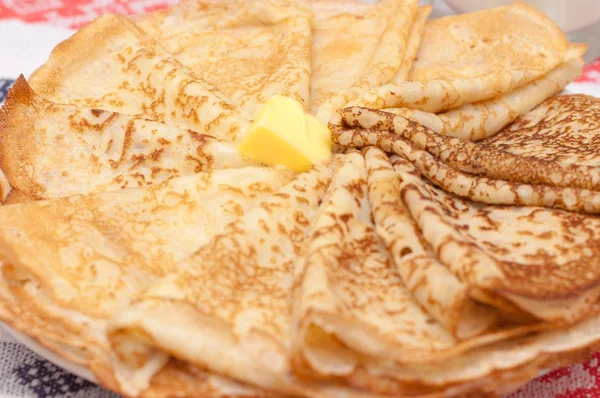 Pancakes and butter on table, closeup view. Healthy breakfast in plate. Pastry at dinner.