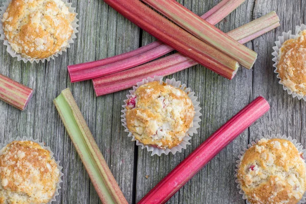 Top View on Rhubarb muffins with rhubarb petioles in the backgro