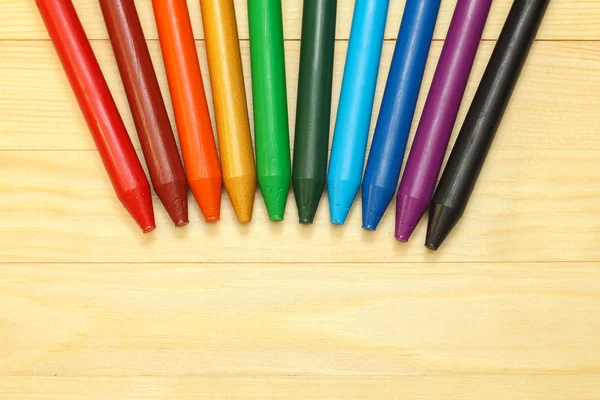 Rainbow  wax crayons  on wood