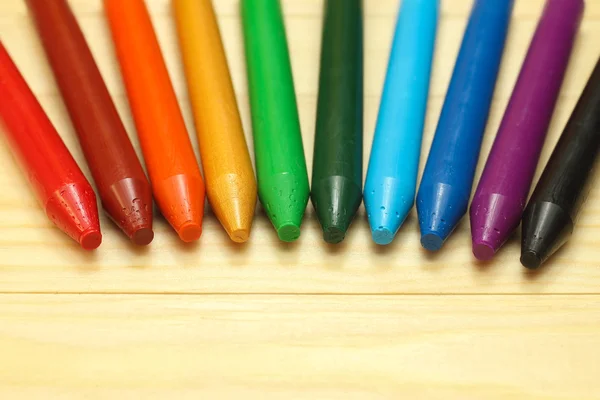 Rainbow  wax crayons  on wood