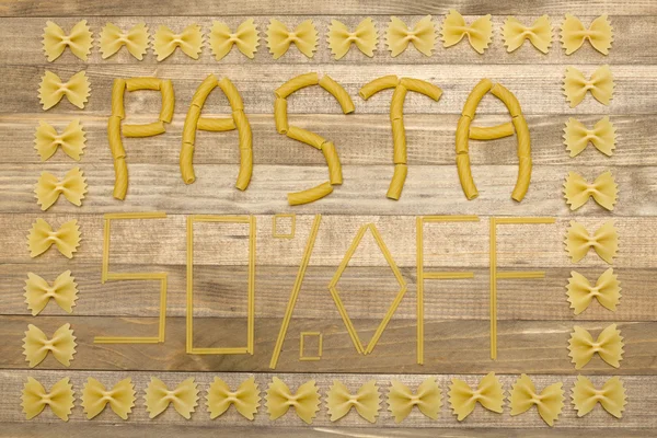 Pasta  fifty percent off text made of raw pasta