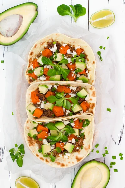 Mexican tacos with meat, sweet potatoes and cotija cheese