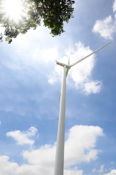 Wind turbine under blue sky - Clean Energy genesis