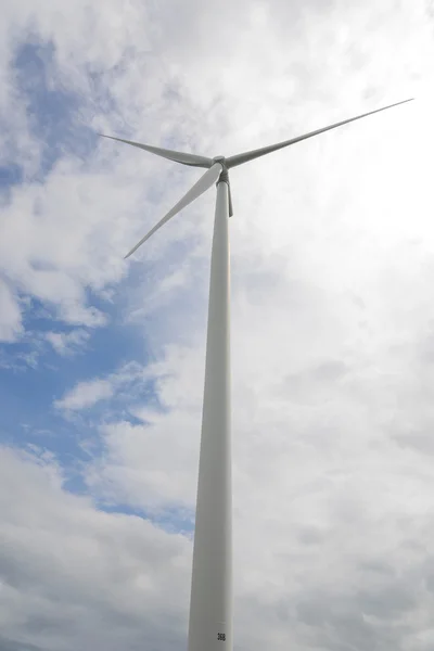 Wind turbine under blue sky - Clean Energy genesis