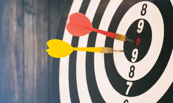 Target dart with target arrows on the bokeh background and dartboard is the target and goalabstract background to target marketing or target arrow or target business concept .