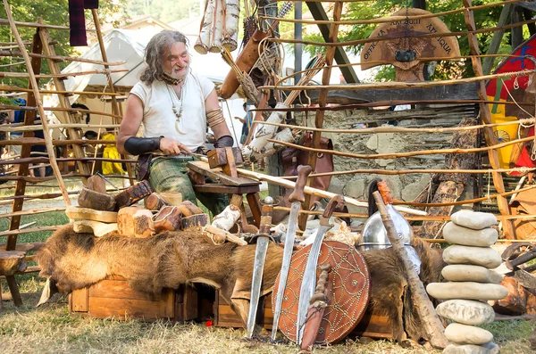 Wood carver craftsman realize swords shields celtic festival medieval reenactment