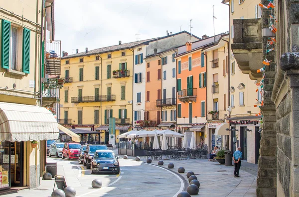 Porretta Terme, Italy - August 2, 2015 - colorful buildings, parked cars and people walking in the town's main street